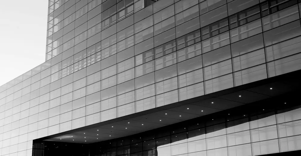 A cantilevered glass and steel structure seen from below.